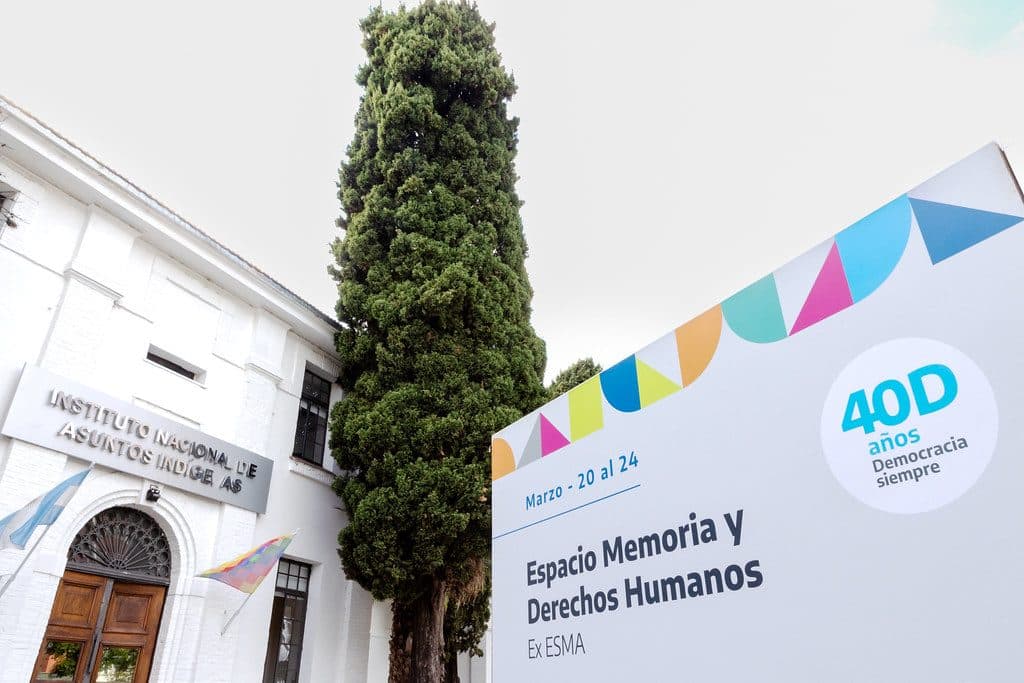 Cartel del Foro en el Espacio Memoria y Derechos Humanos (ex ESMA), con las fechas del 20 al 24 de marzo y el sello de los 40 años de democracia, junto al edificio del Instituto Nacional de Asuntos Indígenas.
