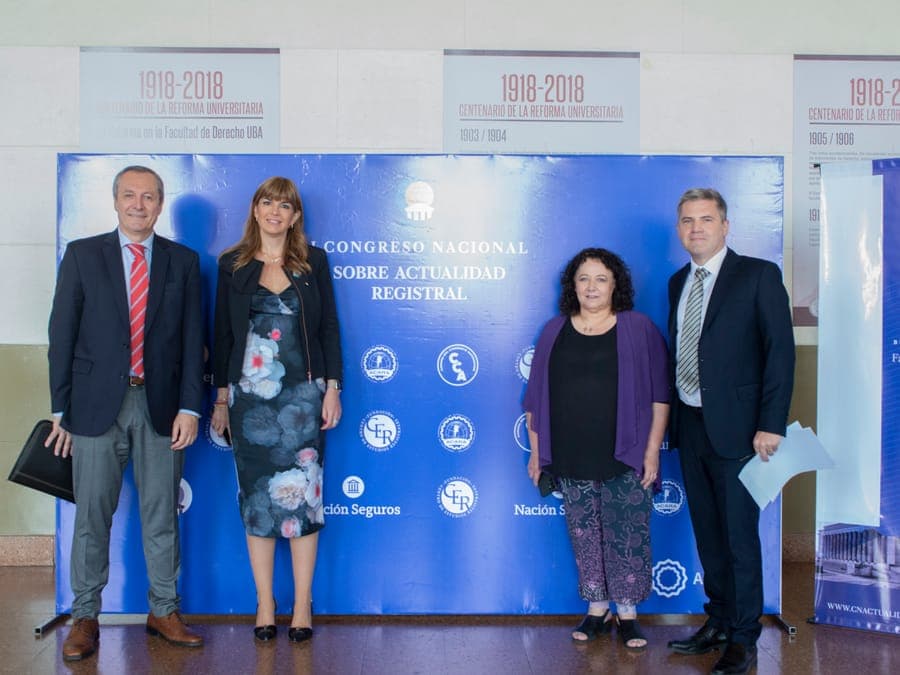 Foto frente al panel de prensa de la primera edición, en la Facultad de Derecho de la UBA.